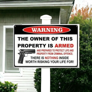 warning the owner is this property is armed metal sign